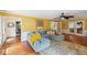 Bright living room with hardwood floors, large windows, fireplace, French doors and comfortable seating at 1218 Chimney Hill Dr, Apex, NC 27502