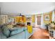 Bright living room with fireplace, recessed lighting, hardwood floors, large windows, and comfortable seating at 1218 Chimney Hill Dr, Apex, NC 27502