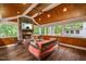 Cozy screened porch features a stone fireplace and comfortable seating with natural light at 1218 Chimney Hill Dr, Apex, NC 27502