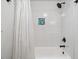 Bright white tiled shower featuring a bathtub and a recessed shelving space at 1218 Chimney Hill Dr, Apex, NC 27502