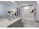 Bright bathroom featuring a single vanity, framed mirror, and shower-tub combination at 1227 Bessie Ct, Wake Forest, NC 27587