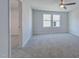 Spacious bedroom with neutral gray carpet, a ceiling fan, and a closet at 1227 Bessie Ct, Wake Forest, NC 27587