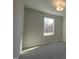 A sunlit bedroom features neutral walls, plush carpeting, and a large window with views of the outdoors at 1227 Bessie Ct, Wake Forest, NC 27587