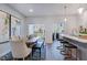 Light-filled dining area with an adjacent open-concept kitchen, with access to outdoor living space at 1227 Bessie Ct, Wake Forest, NC 27587