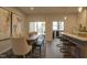 Open dining area with wood table, stylish seating, modern art, and sliding glass doors leading to the exterior at 1227 Bessie Ct, Wake Forest, NC 27587