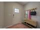 Welcoming entryway with storage bench, coat hooks, mirror, and a stylish rug at 1227 Bessie Ct, Wake Forest, NC 27587