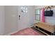 Welcoming entryway featuring a stylish rug, a wooden storage bench, and a coat rack with mirrors at 1227 Bessie Ct, Wake Forest, NC 27587