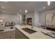 Modern kitchen featuring a center island with a sink, pendant lights, and an open view of the living area at 1227 Bessie Ct, Wake Forest, NC 27587