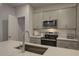 Well-equipped kitchen with stainless steel appliances, a spacious island, and light gray cabinetry at 1227 Bessie Ct, Wake Forest, NC 27587