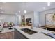 Modern kitchen featuring a center island with a sink, pendant lights, and an open view of the living area at 1227 Bessie Ct, Wake Forest, NC 27587