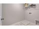 Compact laundry room with white shelves and tile flooring at 1227 Bessie Ct, Wake Forest, NC 27587