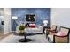 Stylish living room with accent wall, modern furniture, and bright lighting at 1227 Bessie Ct, Wake Forest, NC 27587