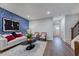 Spacious living room with hardwood flooring, staircase, modern accents, and a comfortable seating area at 1227 Bessie Ct, Wake Forest, NC 27587