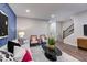 Comfortable living room with stylish decor, patterned accent wall, and contemporary furniture at 1227 Bessie Ct, Wake Forest, NC 27587