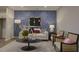 Cozy living room showcasing stylish decor, modern art, hardwood floors, and statement wallpaper at 1227 Bessie Ct, Wake Forest, NC 27587