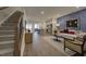 Open-concept living space featuring a staircase, modern kitchen, and stylish living room at 1227 Bessie Ct, Wake Forest, NC 27587