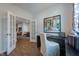 Bright office space showcasing French doors, hardwood floors, modern art, and built in shelving at 1227 Bessie Ct, Wake Forest, NC 27587