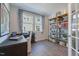 Well-lit home office with a built-in desk, shelving unit, and stylish decor at 1227 Bessie Ct, Wake Forest, NC 27587