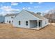 Backyard view of new construction, showcasing a covered patio, lawn, and the home's exterior at 1257 Pond Overlook Drive, Nashville, NC 27856