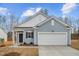 New construction featuring a two-car garage, stylish siding, and a well-maintained front lawn at 1257 Pond Overlook Drive, Nashville, NC 27856