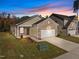 Charming single-Gathering home boasts a brick-accented facade and attached two-car garage at 1257 Pond Overlook Drive, Nashville, NC 27856