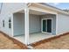 Covered patio with concrete flooring, open siding and sliding glass doors to the home's interior at 1257 Pond Overlook Drive, Nashville, NC 27856