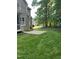 Spacious backyard with patio, lush lawn, and mature trees, ideal for outdoor activities and entertaining at 126 Riverglade Dr, Clayton, NC 27527