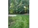 Picturesque backyard featuring lush green grass, a patio, and mature trees for serene outdoor enjoyment at 126 Riverglade Dr, Clayton, NC 27527