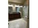 Bathroom with double sink, glass shower, tile floor, and a soaking tub at 126 Riverglade Dr, Clayton, NC 27527