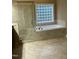 Bathroom featuring a soaking tub, glass enclosed shower, and tile flooring at 126 Riverglade Dr, Clayton, NC 27527
