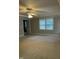 Bright bedroom featuring carpet, large windows, and crown molding; bathroom door is visible at 126 Riverglade Dr, Clayton, NC 27527