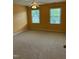 Bedroom featuring neutral carpet, two windows, and ceiling fan at 126 Riverglade Dr, Clayton, NC 27527