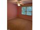 Pink bedroom with carpet, window, and a ceiling fan at 126 Riverglade Dr, Clayton, NC 27527
