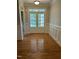Inviting foyer with hardwood floors, classic trim, and double glass front doors letting in ample light at 126 Riverglade Dr, Clayton, NC 27527