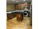 Modern kitchen with stainless steel appliances, granite countertops, custom cabinets, and hardwood floors at 126 Riverglade Dr, Clayton, NC 27527