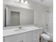 Bathroom featuring a shower and tub combination, white toilet, vanity with quartz countertop, and large mirror at 1271 Pond Overlook, Nashville, NC 27856