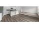 Open-concept kitchen featuring white cabinets, granite countertops, stainless steel appliances, and modern wood flooring at 1271 Pond Overlook, Nashville, NC 27856