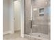 Modern bathroom featuring a tiled walk-in shower with a glass door and tiled niche at 13 Knotty Pine Lane, Clayton, NC 27520
