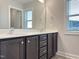 A bathroom with a double sink vanity topped with a white countertop under a large mirror at 13 Knotty Pine Lane, Clayton, NC 27520
