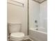Functional bathroom with a toilet and bathtub/shower combination with light gray tile surround at 13 Knotty Pine Lane, Clayton, NC 27520