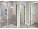 Modern bathroom showcasing walk-in shower with glass door and open doorway to another room at 13 Knotty Pine Lane, Clayton, NC 27520