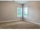 Comfortable bedroom with neutral walls, plush carpeting, and natural light from the double windows at 13 Knotty Pine Lane, Clayton, NC 27520