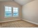 Bright bedroom featuring a large window with blinds and neutral carpet at 13 Knotty Pine Lane, Clayton, NC 27520