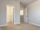 Bedroom with neutral carpet and view of two walk-in closets at 13 Knotty Pine Lane, Clayton, NC 27520