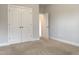 Cozy bedroom with neutral walls, plush carpeting, and a spacious closet at 13 Knotty Pine Lane, Clayton, NC 27520
