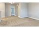 Empty bedroom with neutral carpet, walls, and open doorway at 13 Knotty Pine Lane, Clayton, NC 27520