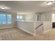 Upstairs hallway with access to a bathroom and spacious carpeted landing area at 13 Knotty Pine Lane, Clayton, NC 27520