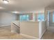 Upstairs hallway showing the stairs, neutral walls, and carpet in a new home at 13 Knotty Pine Lane, Clayton, NC 27520