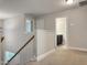 Upstairs hallway showcasing access to the bathroom and view of the stairs at 13 Knotty Pine Lane, Clayton, NC 27520