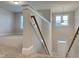 Hallway landing features a wooden banister and trim with natural lighting at 13 Knotty Pine Lane, Clayton, NC 27520
